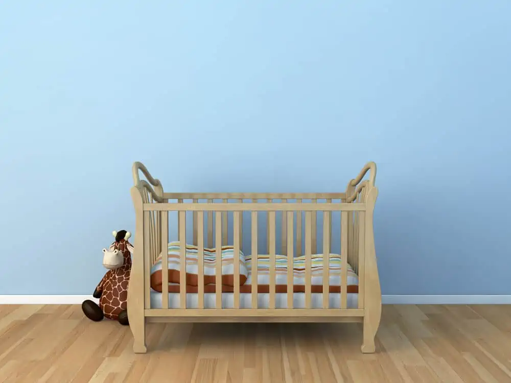 Baby Bed in front of blue wall