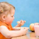 Little girl eating healthy baby food