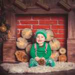 baby in front of closed up fireplace