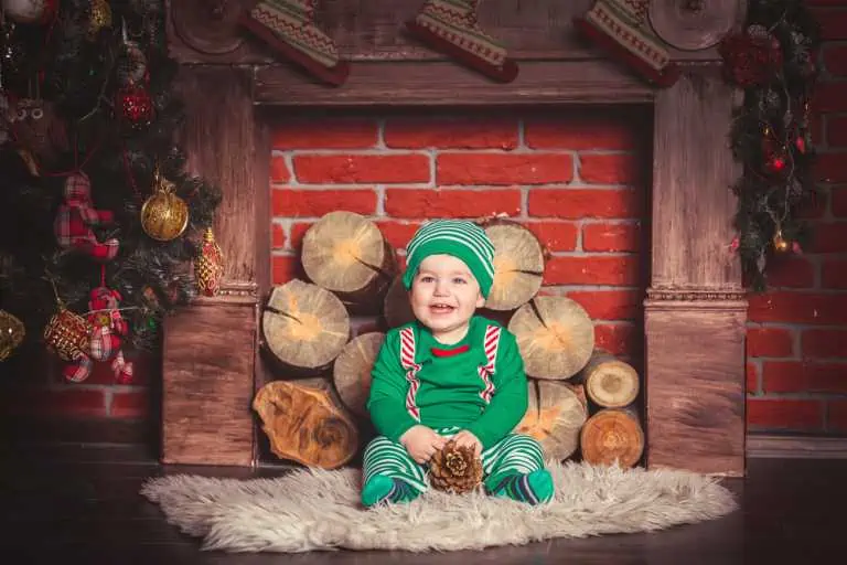 baby in front of closed up fireplace