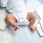 Baby with Diapers lying around