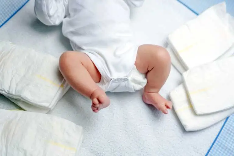 Baby with Diapers lying around