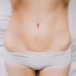 Closeup of woman belly with a scar from a cesarean section