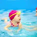child swimming with mother