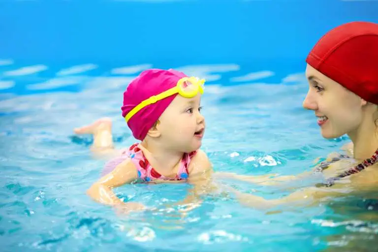 child swimming with mother