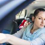 A Mother driving with Baby in the back