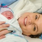 Smiling Mother with Baby shortly after a c-section