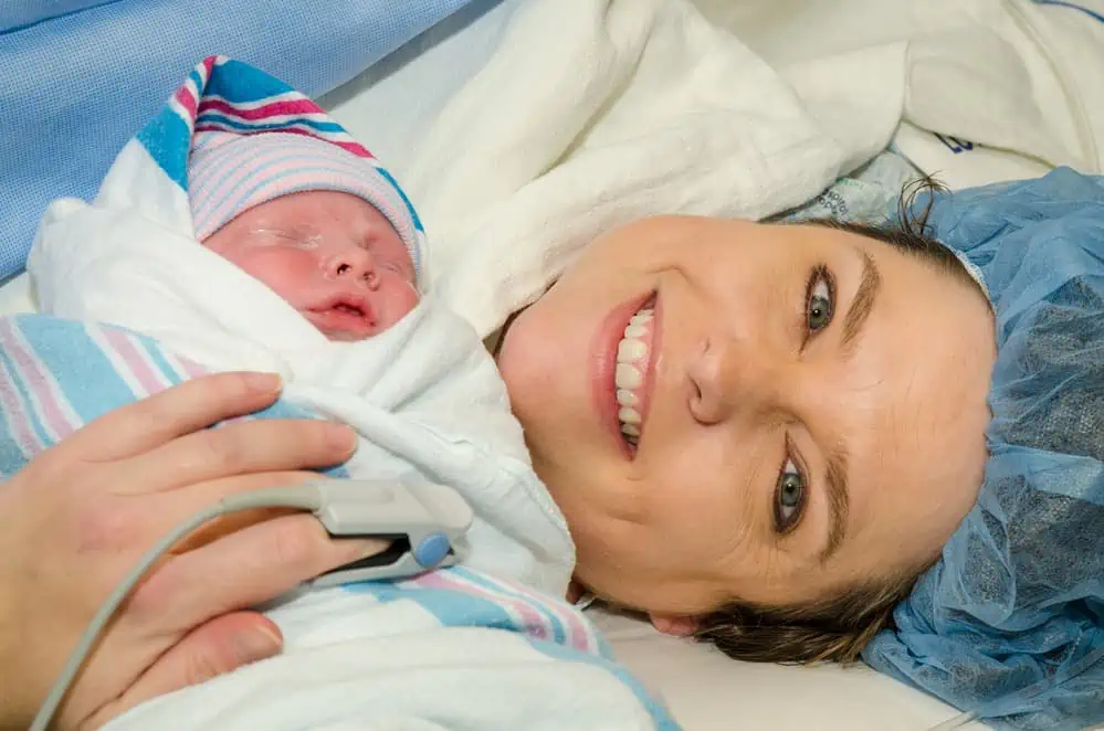 Smiling Mother with Baby shortly after a c-section