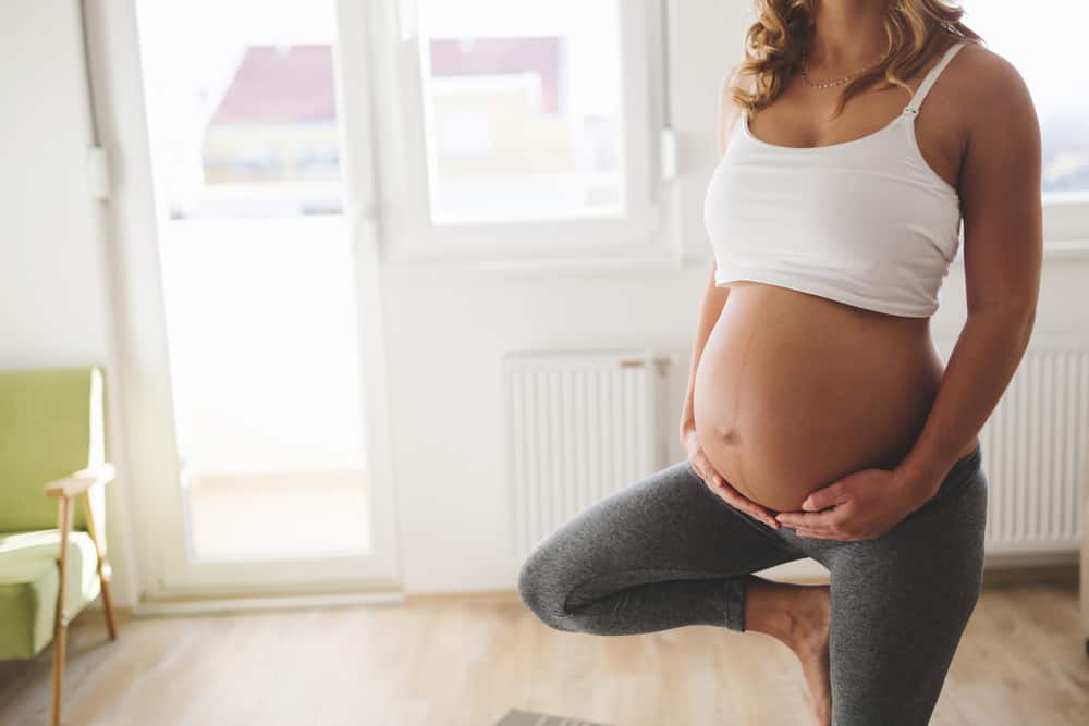 Exercising pregnant woman at home