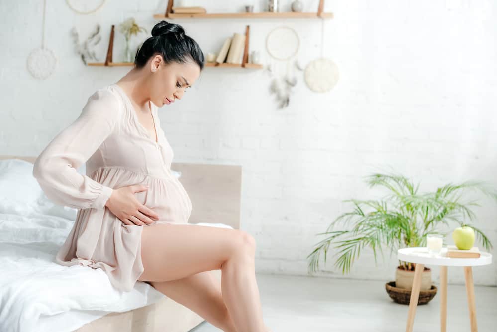 A Pregnant woman feeling for babykicks