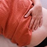 Woman after Cesarean checks belly