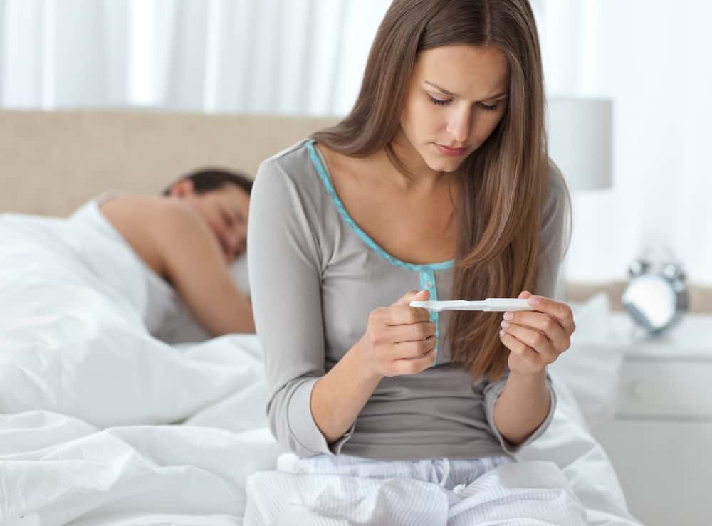 Woman looking at a pregnancy test