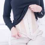 woman close up wearing a waist trainer