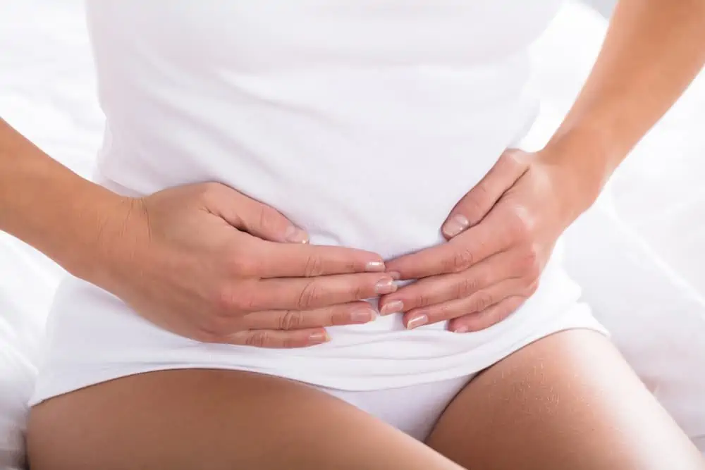 Woman holds her stomach after a c-section