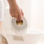 Woman in bath with toilet paper