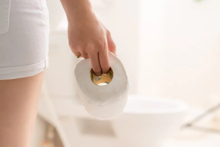 Woman in bath with toilet paper