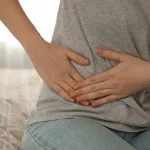 Woman suffering from pain on the right side.