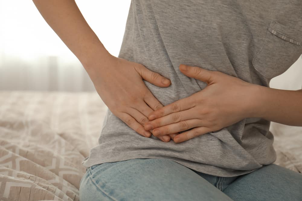 Woman suffering from pain on the right side.