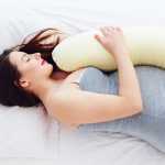 woman sleeps on side with pillow