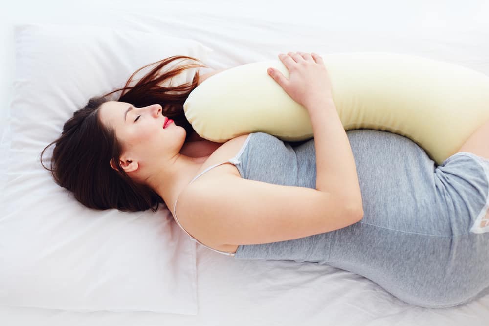woman sleeps on side with pillow
