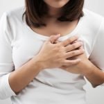 Woman squeezes her breast