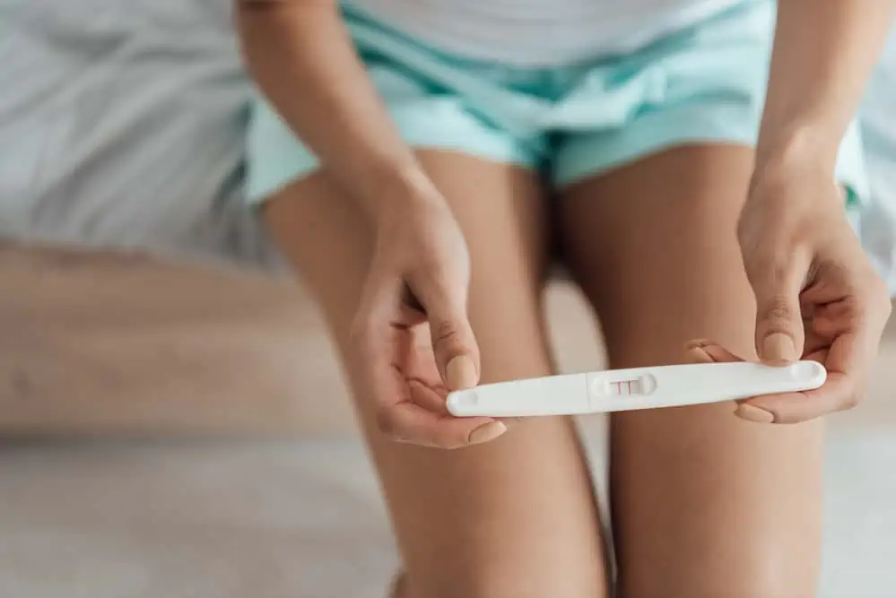 woman with positive pregnancy test